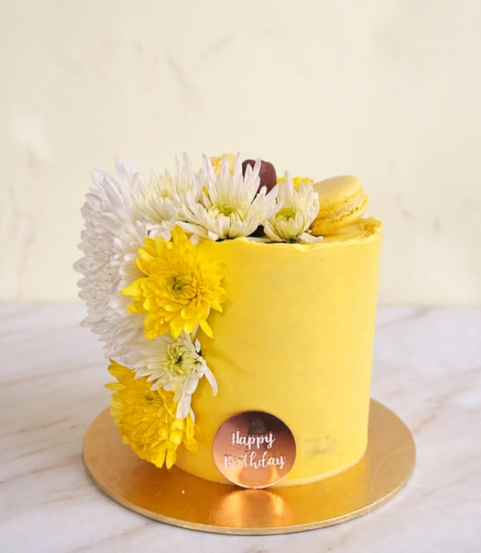 Sunshine yellow buttercream cake with white and yellow chrysanthemums