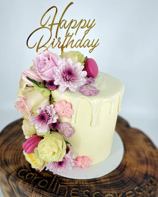Tall blush pink buttercream cake topped with garden roses